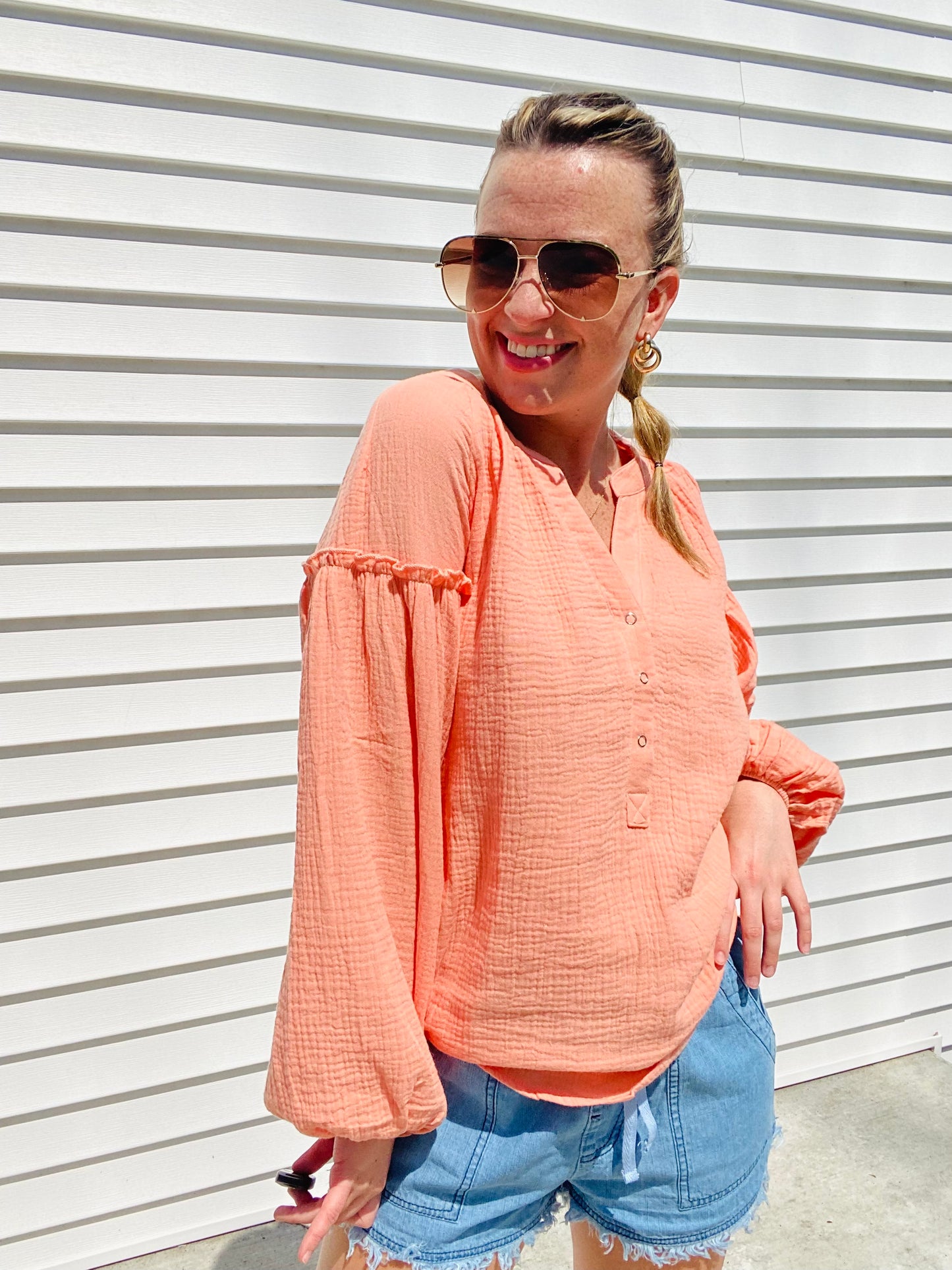 The Coral Love Gauzy Crinkle Top is the perfect addition to your wardrobe. Featuring casual balloon sleeves and functioning buttons, this top is ideal for achieving a relaxed yet stylish look. Wear it with denim and sandals for an effortless yet cute outfit.