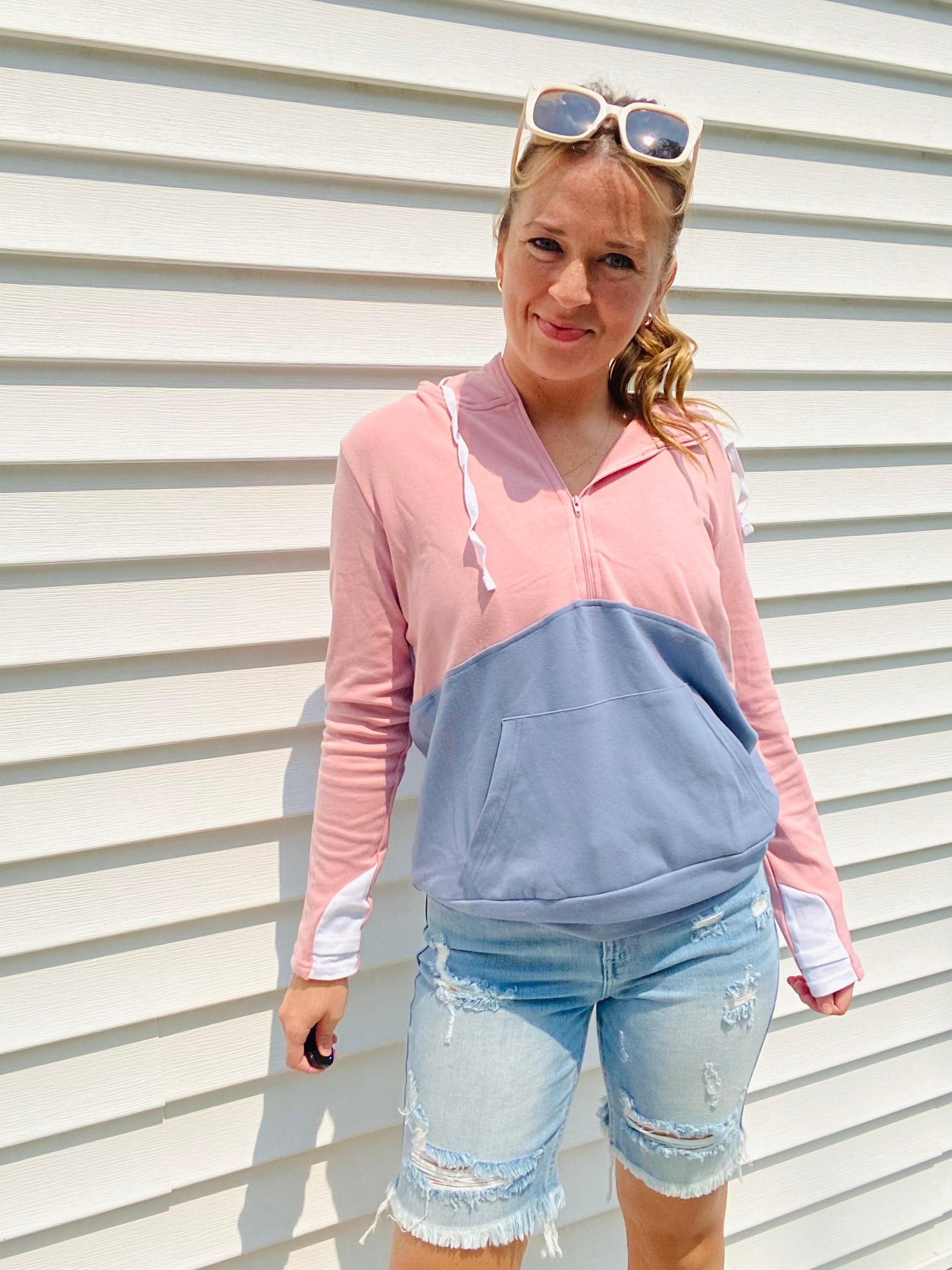 Stay warm and stylish with the Pink and Blue Block Zip Hoodie. Crafted with comfortable materials, this hoodie features contrasting colors, a half zipper, white cuff accents, and an oversized hood. Perfect for chilly days and nights - stay cozy in style!