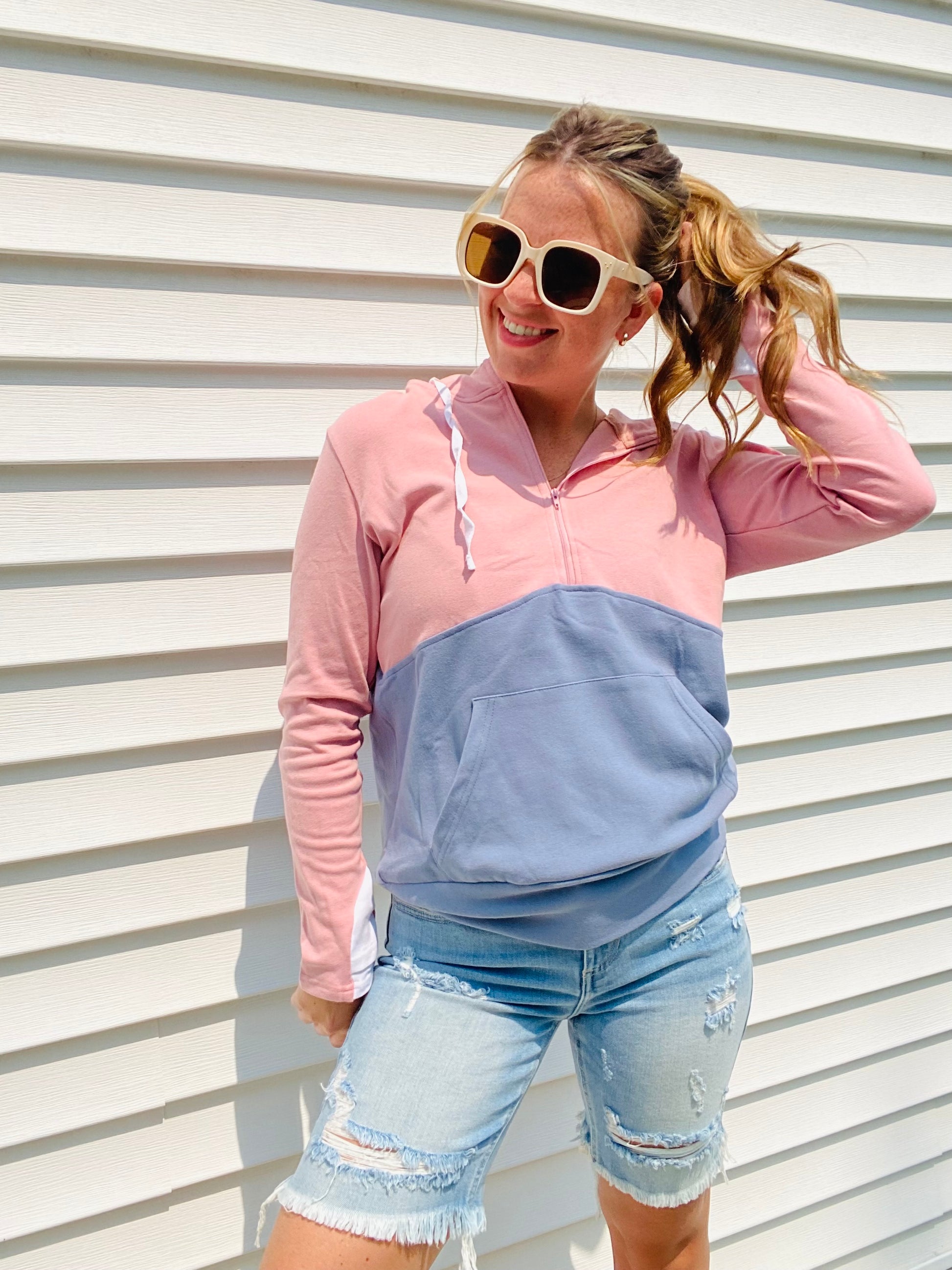 Stay warm and stylish with the Pink and Blue Block Zip Hoodie. Crafted with comfortable materials, this hoodie features contrasting colors, a half zipper, white cuff accents, and an oversized hood. Perfect for chilly days and nights - stay cozy in style!