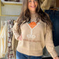 Bring a little seasonal personality to your wardrobe with the Pumpkin Martini Sweater from Sunday Edition. With its playful name and festive fall-inspired feel, this sweater is an easy way to add charm to your everyday lineup. Style it with your favorite denim and boots for a relaxed weekend look, or pair it with a skirt for a fun, polished take on seasonal dressing.

Why you’ll love it:

Playful Pumpkin Martini theme
Easy everyday sweater style
Perfect for fall outings, casual gatherings, and seasonal cele