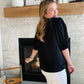This Black Smocked Sleeve V Neck Blouse is perfect for any occasion. Crafted from high quality fabric, it features a flattering v neckline and black half sleeve. Its versatile design pairs well with white denim for a chic and timeless style.