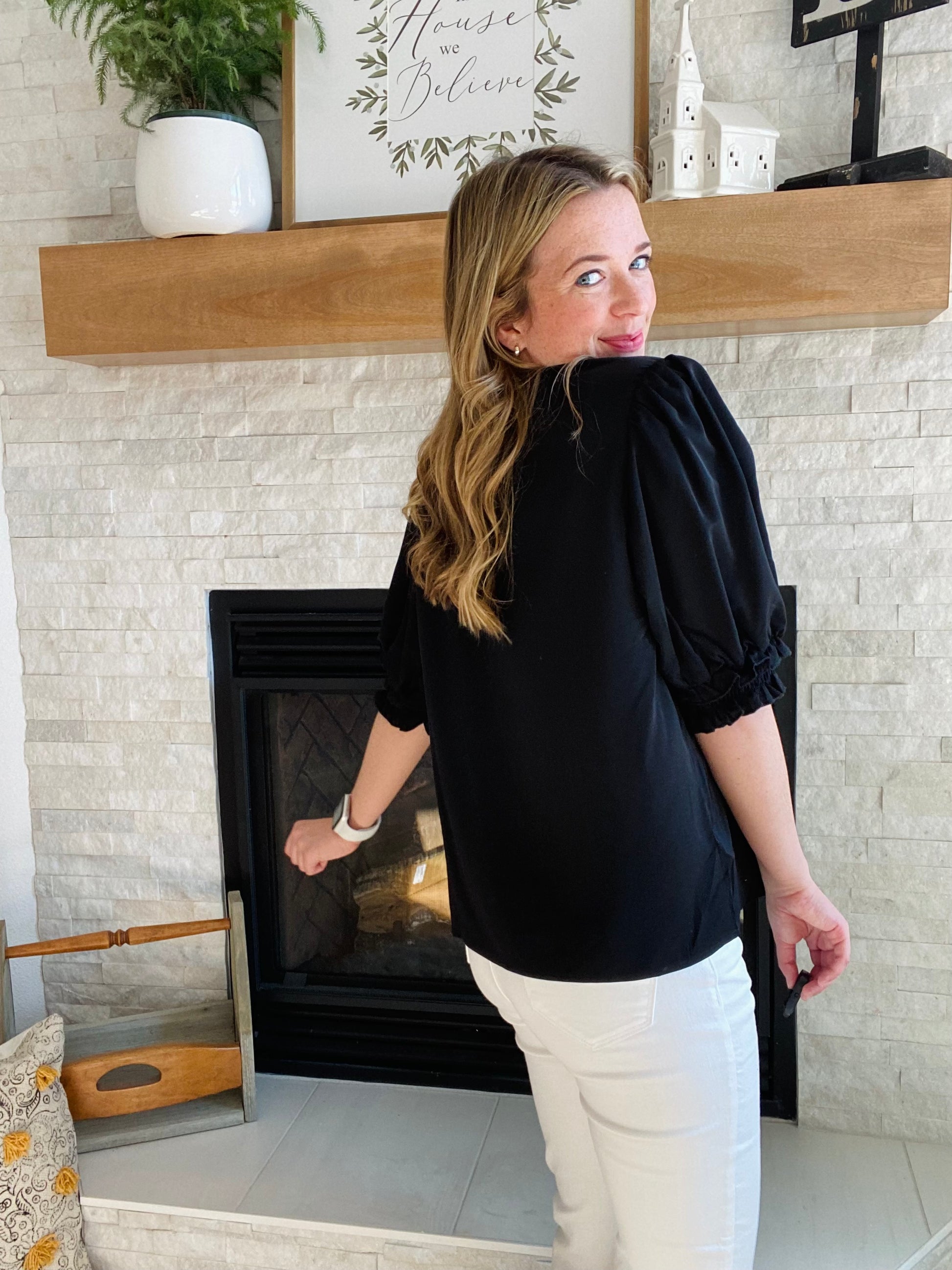 This Black Smocked Sleeve V Neck Blouse is perfect for any occasion. Crafted from high quality fabric, it features a flattering v neckline and black half sleeve. Its versatile design pairs well with white denim for a chic and timeless style.
