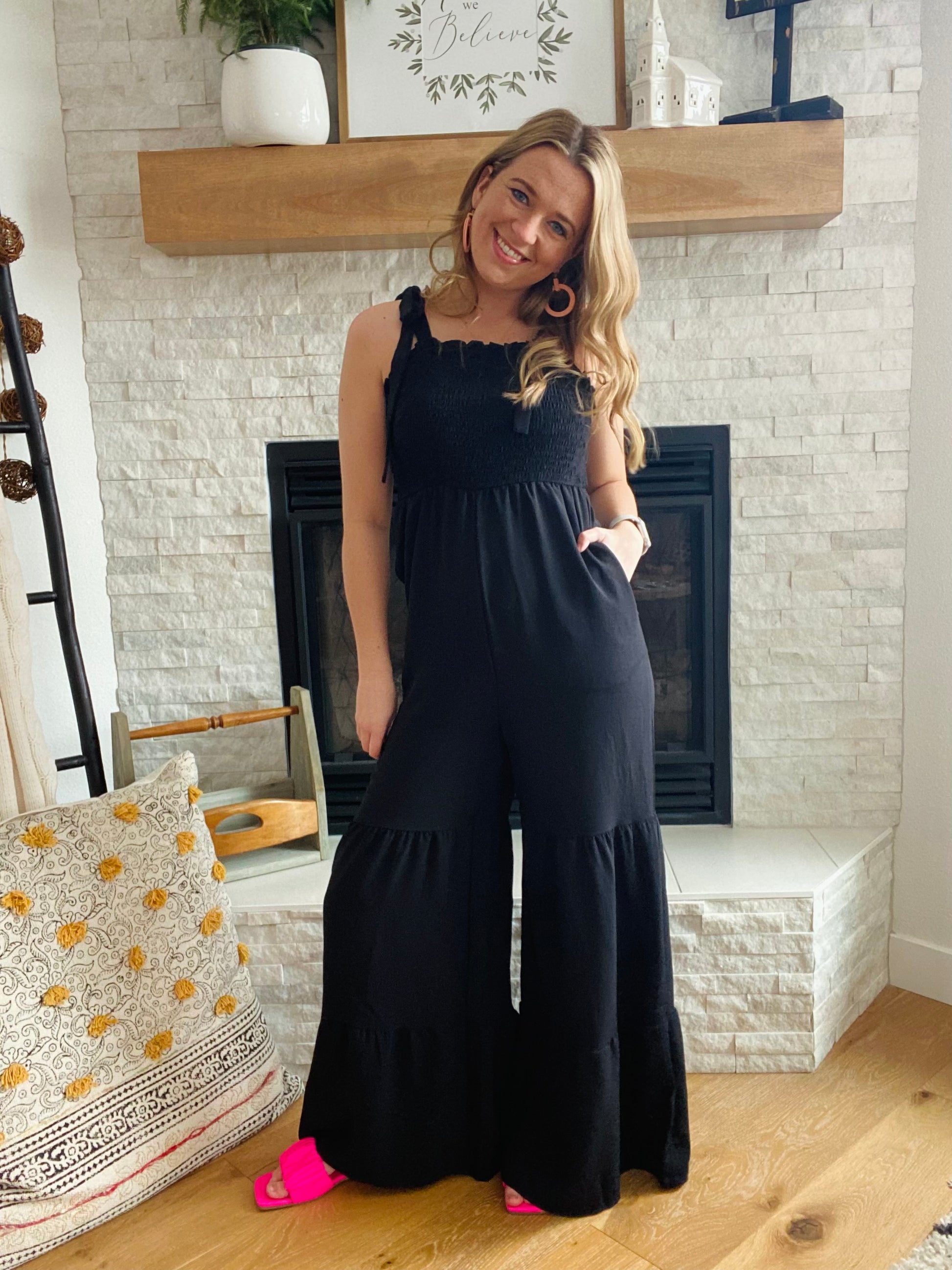 This Black Tiered Wide Leg Jumpsuit provides comfort and style. Made from a comfy fabric with a wide leg detail, you'll be ready for any occasion with this women's pant jumpsuit. Complete the look with a jean jacket and some fun sandals for a stylish, comfortable outfit.
