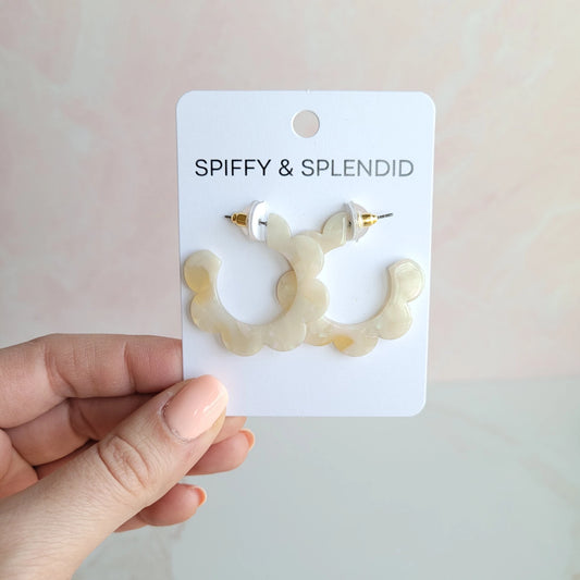 Add a retro vibe to your outfit with our Flora Hoops. The floral design gives these earrings a unique, eye-catching look that's sure to turn heads.  Their lightweight design makes them perfect for everyday wear, while the bright colors make them ideal for a fun night out.