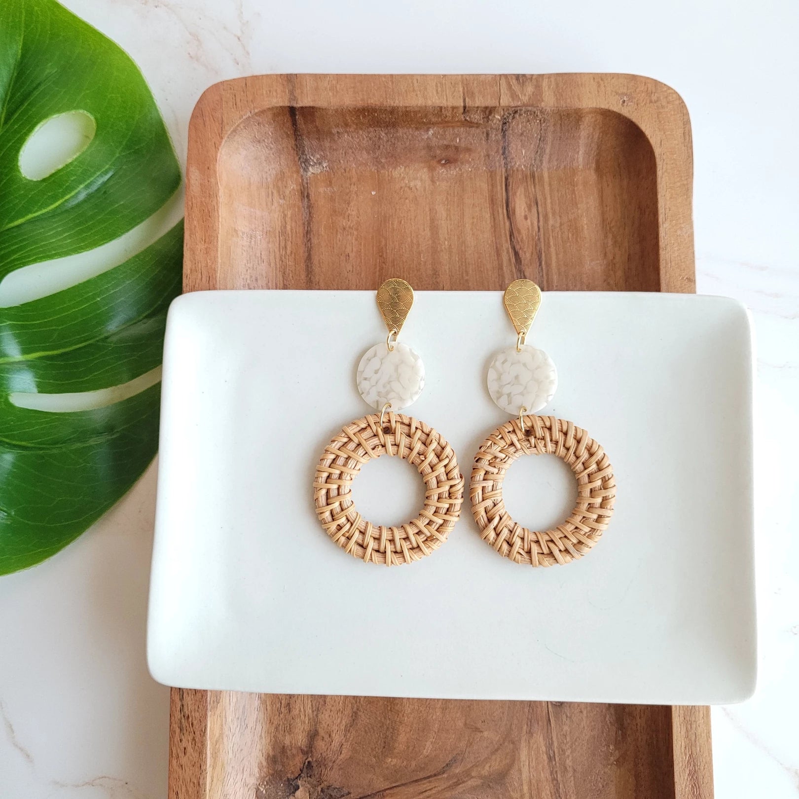  Bring a little bit of resort wear glam to your everyday style with these lightweight, rattan earrings. We've hooked you up with the perfect statement earrings with a trendy twist on our classic rattan look. The gold accents and acrylic only add to their luxurious feel and make them perfect for pairing with any outfit.