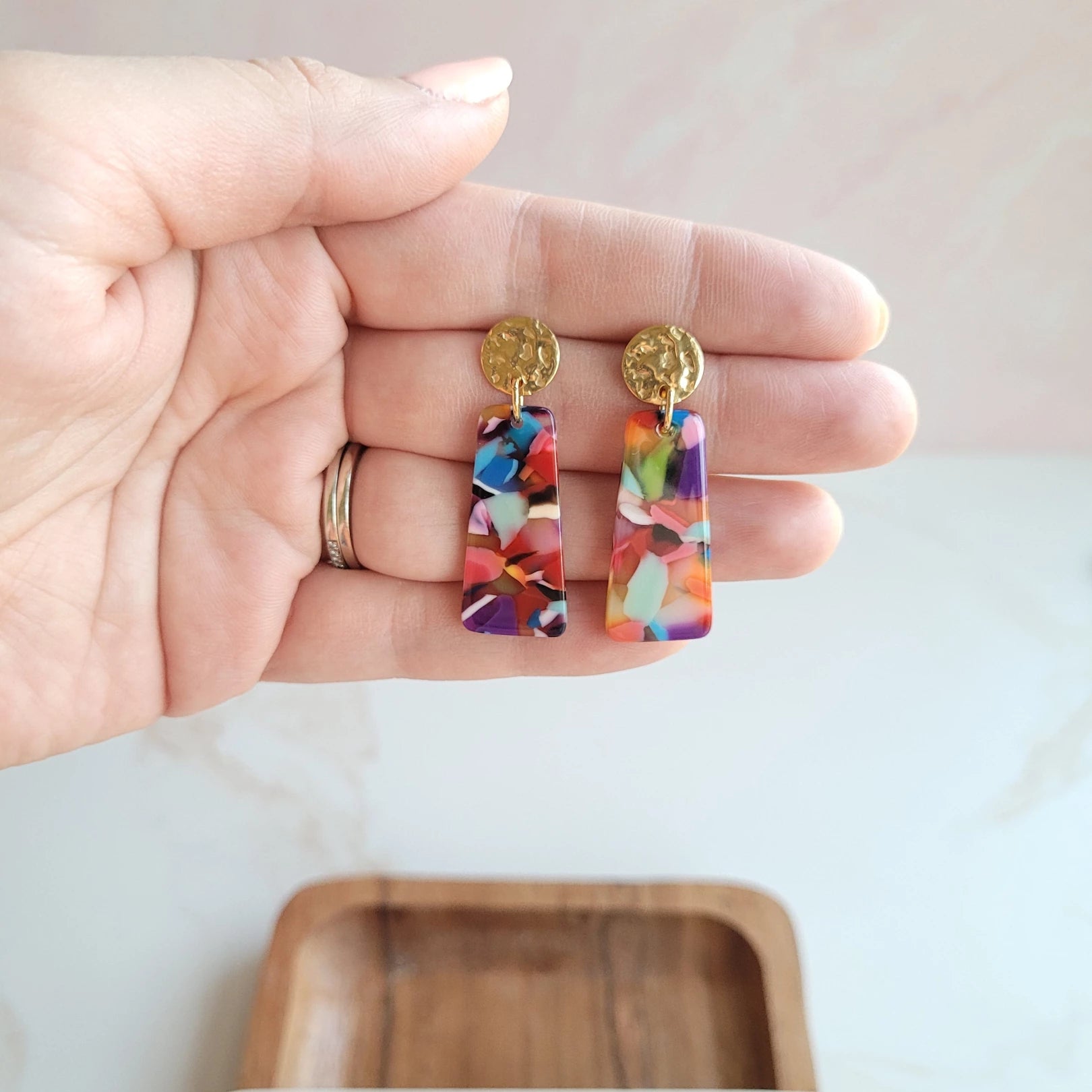 Our Mia Mini Earrings feature a fun pop of color with gold stud accents. These dainty earrings make the perfect finishing touch to any outfit, while still being small and delicate enough to wear every day.