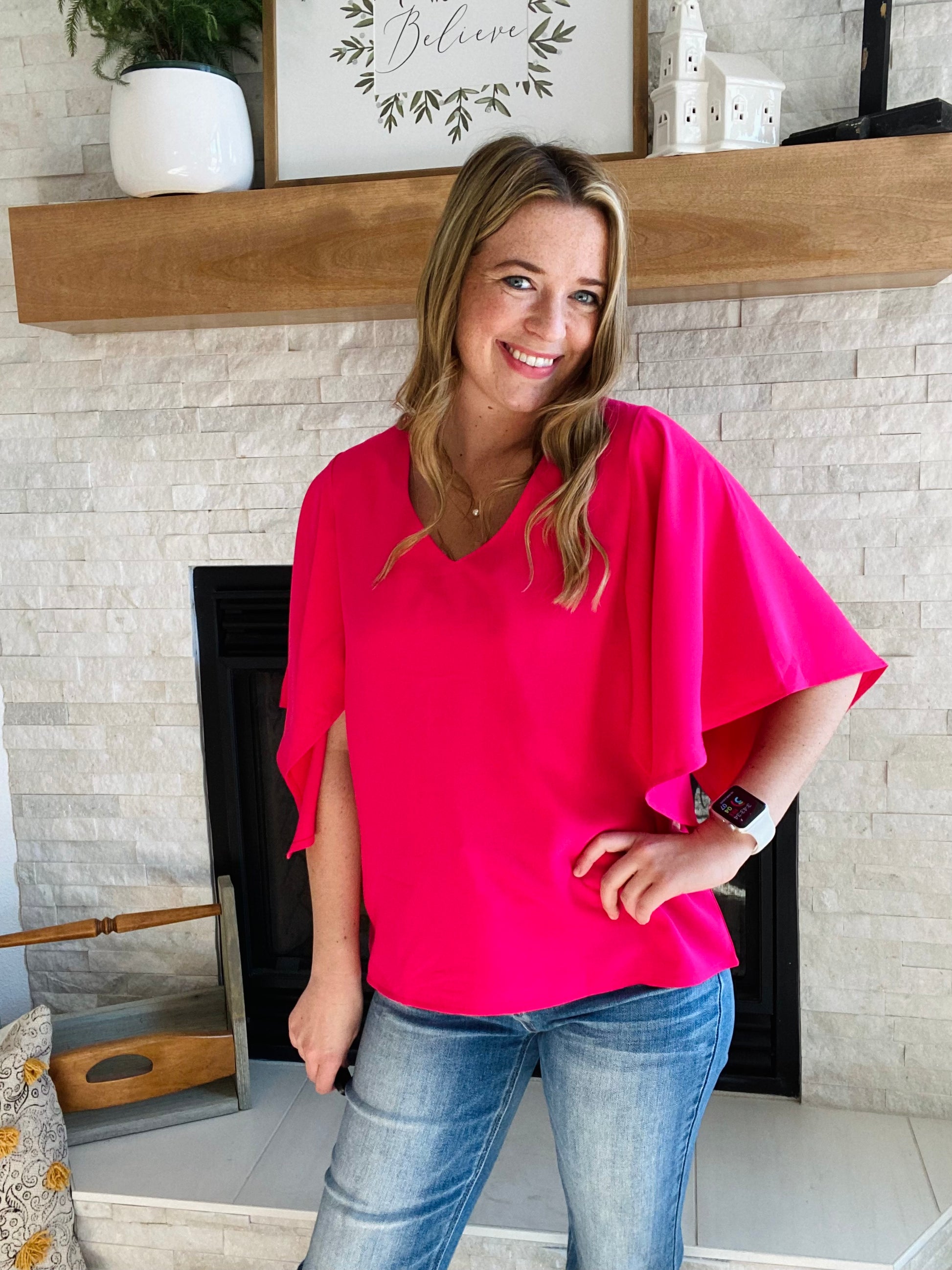 Look your best in the office this summer with the Rose Flounce Bell Sleeve Blouse. The contemporary silhouette features a distinctive bell sleeve and neon pink hue, perfect for making a statement! This style pairs effortlessly with denim and black pants, making it a versatile addition to your wardrobe. Look sharp and stay cool this season.
