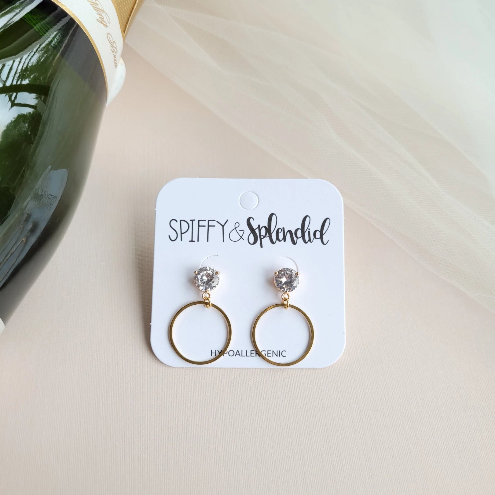 Our I Do Earrings are the cutest little earrings that look exactly like an engagement ring! These are perfect for engagement parties and beyond. Plus, bride or not, these earrings are perfect for wedding guests or just to add a formal touch to any look.  Zircon stud posts on gold-plated brass 18k gold-plated stainless steel dainty loops